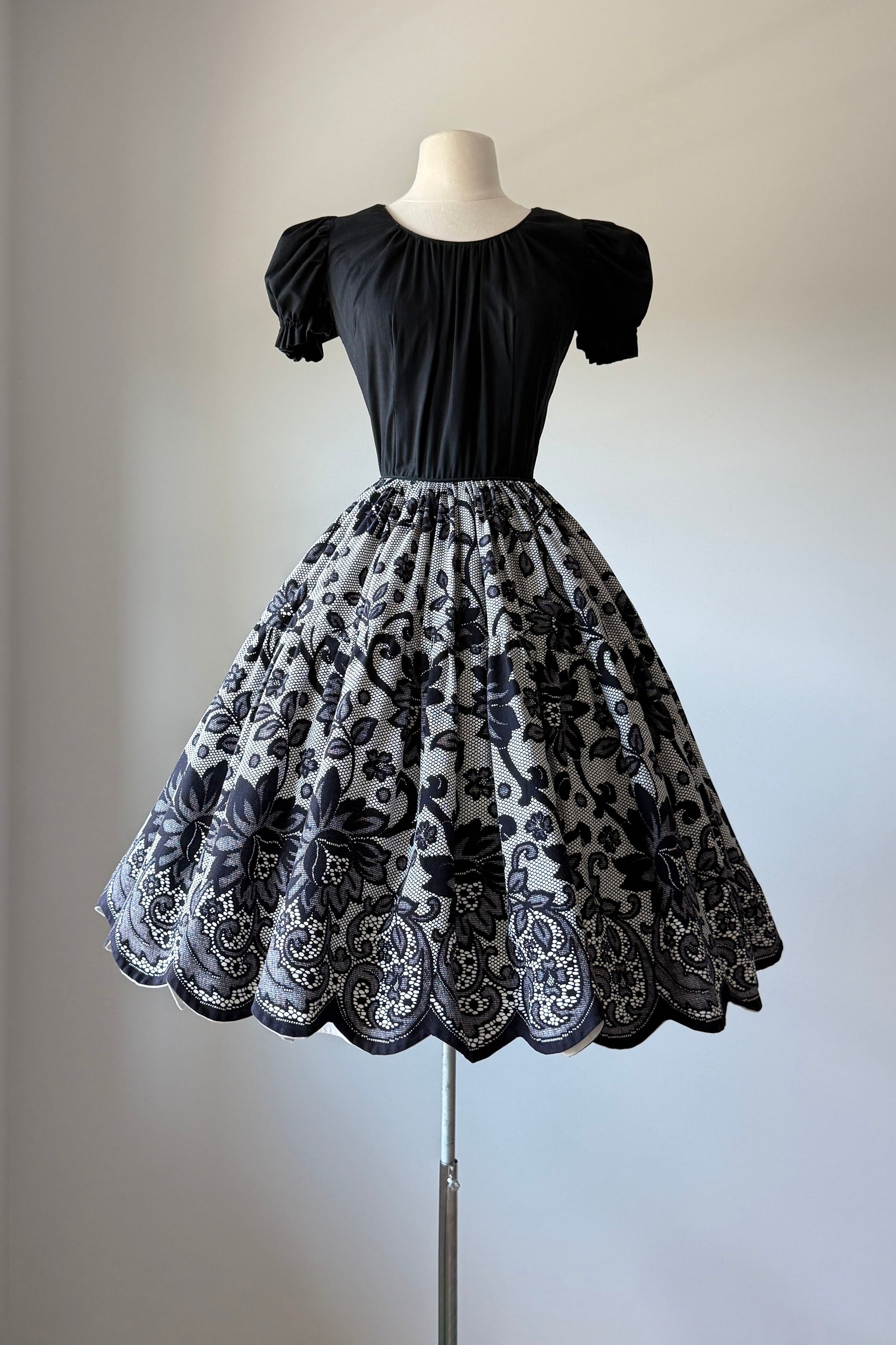 vintage black dress with sleeves Vintage 1970's Black Tissue Weight Cotton and Lace Tapered Angel Sleeve Dress With a Dramatic Hi-lo Hem and Stunning Smocked Waistline. Vamp